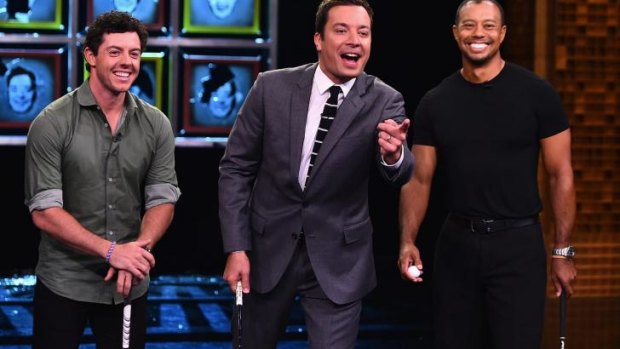 Rory Mcllroy and Tiger Woods flank US comedian Jimmy Fallon on the set of "The Tonight Show."