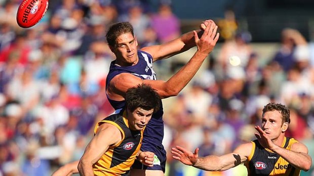 Aaron Sandilands of the Dockers handballs during the match against Richmond in Perth.