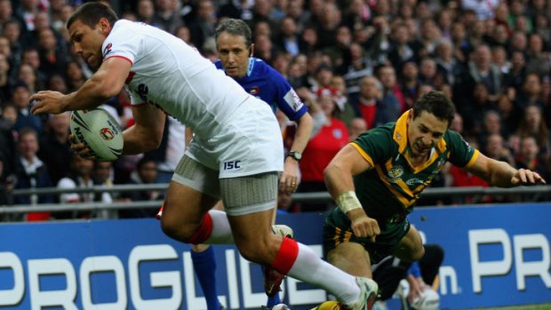 Opening salvo ... Ryan Hall of England scores the opening try as Billy Slater breaks his collarbone in the tackle.