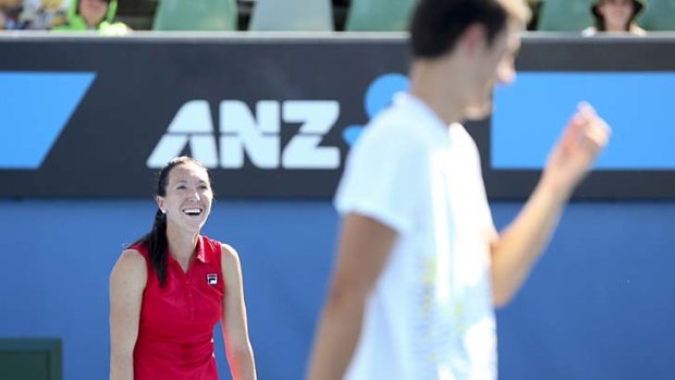 Nothing to lose: Bernard Tomic has a light moment during the mixed doubles defeat with Jelena Jankovic yesterday.