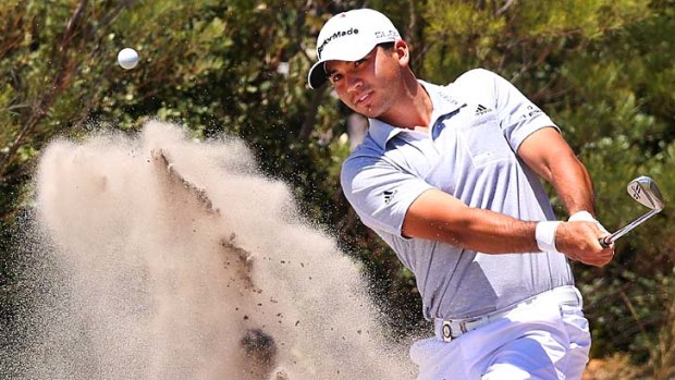 Jason Day finds his way out of one of Royal Melbourne's tough bunkers.