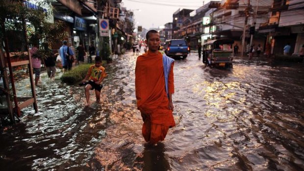 A Buddhist monk in a flooded street in central Bangkok. The government is struggling as Thailand experiences its worst floods in 50 years.