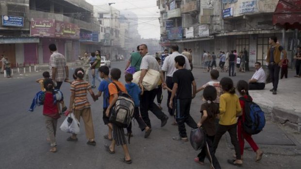 Residents flee the neighbourhood of Shujaiya during a brief ceasefire.
