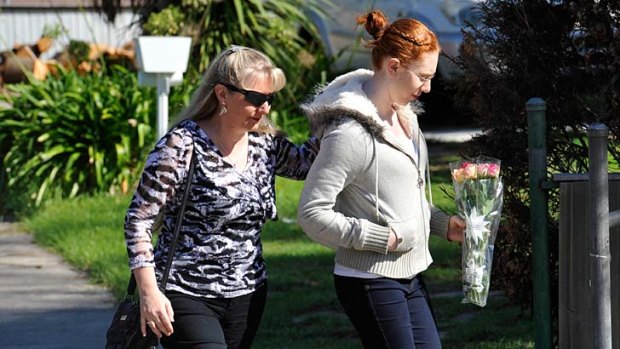 In mourning: Mikayla Bishop and her mother Sandra, a former teacher, arrive at Montmercy Secondary College yesterday.