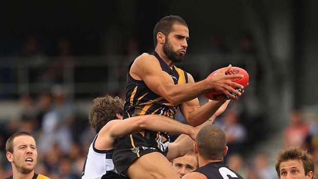 It's mine: Richmond's Bachar Houli wins the ball in a pack of Cats.
