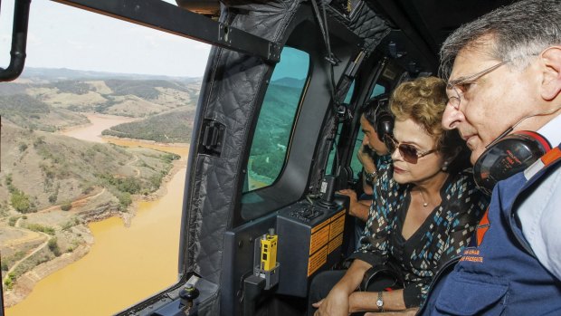 President Dilma Rousseff accompanied by Minas Gerais state Governor Fernando Pimentel, looks out over the dam site.
