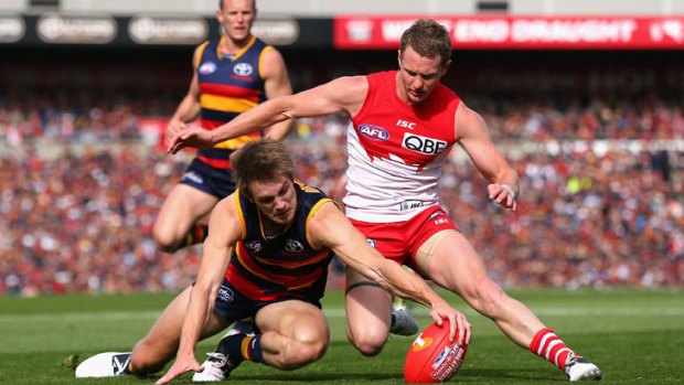 The Crows' Sam Shaw, pictured competing for the ball with the Swans' Mitch Morton, will be missing against Hawthorn.