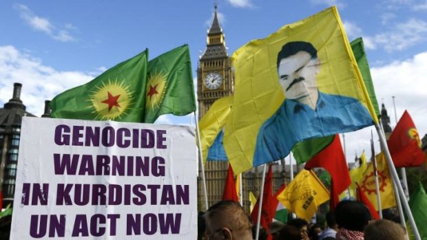 Demonstrators hold the image of imprisoned Kurdish leader Abdullah Ocalan outside the British parliament.