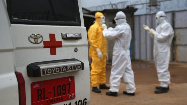 Health workers don protective clothing in Liberia.