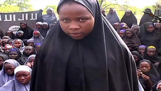 A girl wearing the full-length hijab talks to the camera.