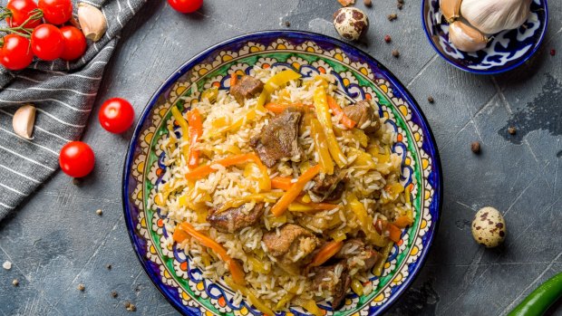 Uzbekistan's national dish and daily ritual, a hefty rice pilaf cooked with meat, onions, carrots, garlic, dried fruit, and a fair glug of oil.