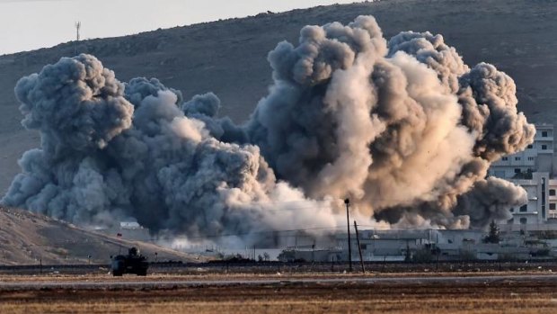Telling reminder: Smoke rises during air strikes on Kobane, viewed from the Turkish-Syrian border, as coalition fighter jets increase attacks on Islamic State positions.