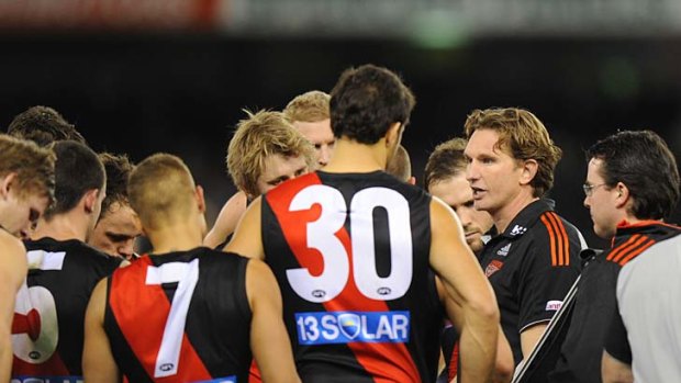 Listen up: Essendon coach James Hird asks his players for a big last-quarter effort yesterday.