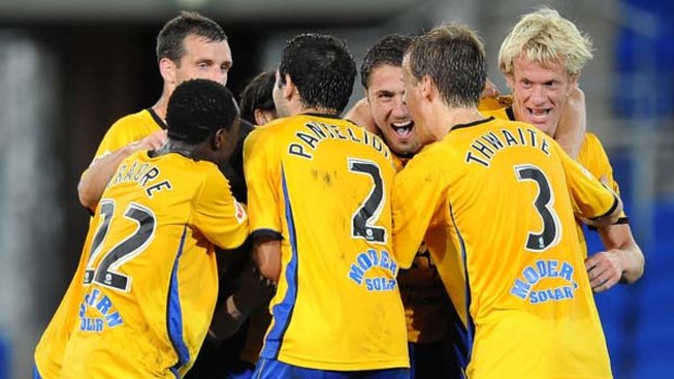 Gold Coast United players celebrate the last minute goal.