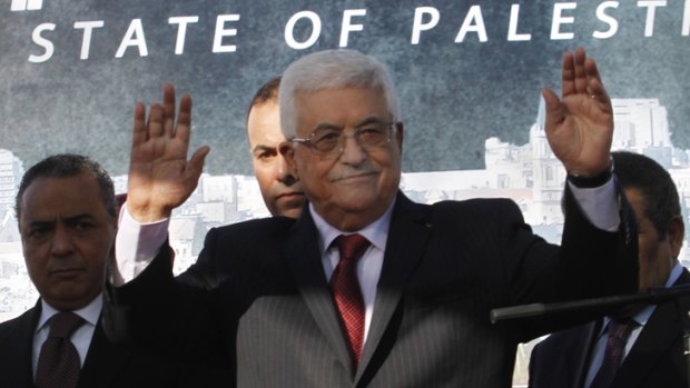 Palestinian President Mahmoud Abbas, waves to the crowd during celebrations for their successful bid to win U.N. statehood recognition in the West Bank city of Ramallah, Sunday, Dec. 2, 2012.
