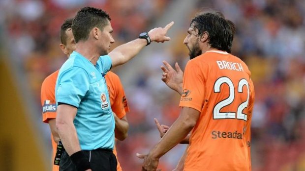 Thomas Broich of the Roar argues with referee Ben Williams after team mate Matthew McKay is sent from the field during the round one A-League match against Adelaide United at Suncorp Stadium.
