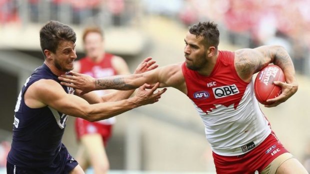 The fend-off: Buddy Franklin pushes off Alex Silvagni.