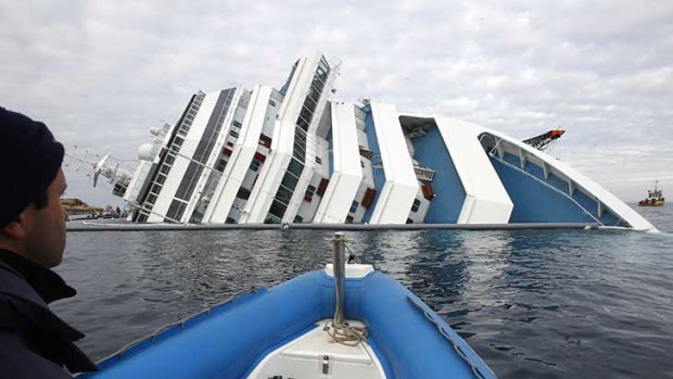An Italian fire crew approaches the grounded Costa Concordia off the Tuscan coast.