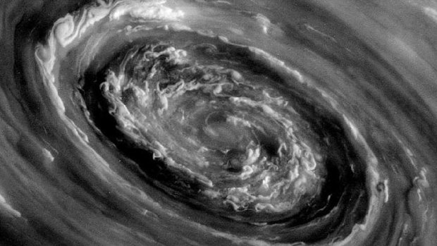 Roiling storm clouds and a swirling vortex at the center of Saturn's famed north polar hexagon is seen in an image from NASA's Cassini mission