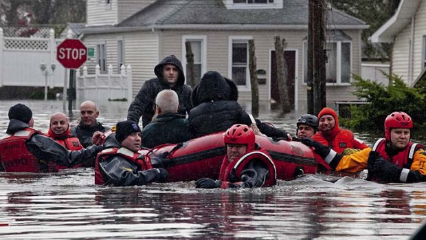 A family is rescued from the Dongan Hills neighborhood in the Staten Island borough of New York.