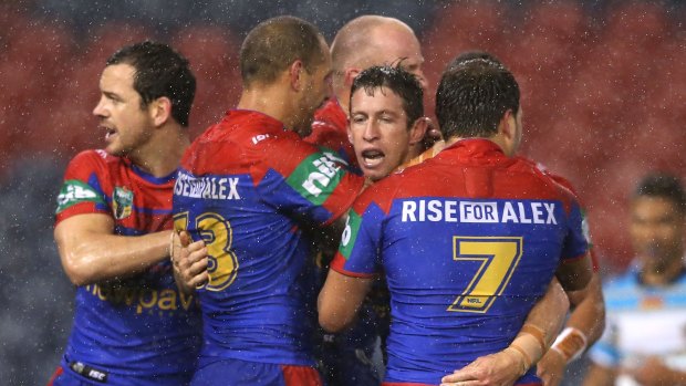 Drought-breaking win: Kurt Gidley celebrates with Knights teammates after scoring.