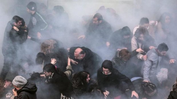 Riot police use water cannons and tear gas to disperse thousands of people taking part in a march.