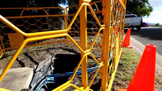 Down a hole ... fibre optic cables being installed in Kiama for the national broadband network.