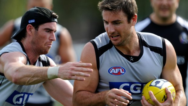 Darren Jolly, right, in Magpies training.