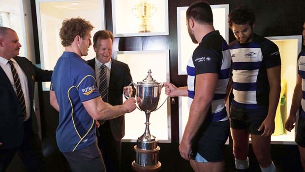 Game pride: The Sydney Convicts hand over the Bingham Cup to Bill Pulver of the ARU.