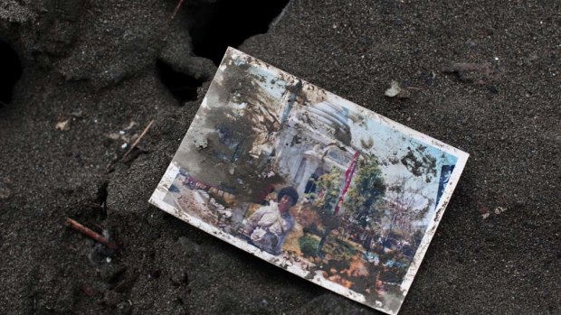 A family photograph is seen amongst the rubble  in Rikuzentakata, Japan..