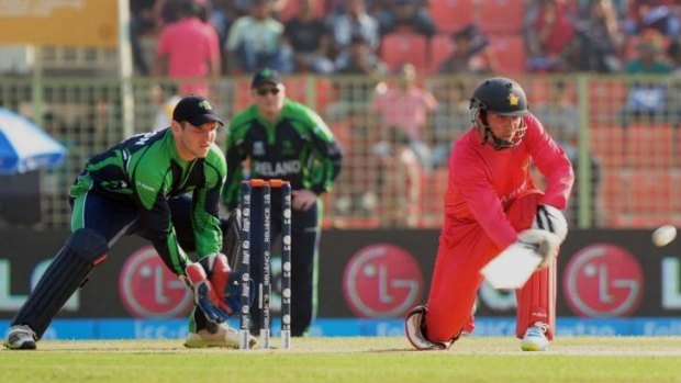 Zimbabwe's Brendan Taylor sweeps as Ireland wicketkeeper Gary Wilson looks on during the World Twenty20 tournament game in Sylhet on Monday.