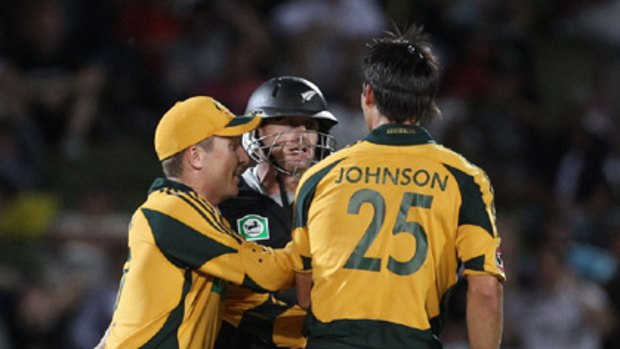 Brad Haddin (L) runs in to separate Scott Styris and Mitchell Johnson during an exchange of words.