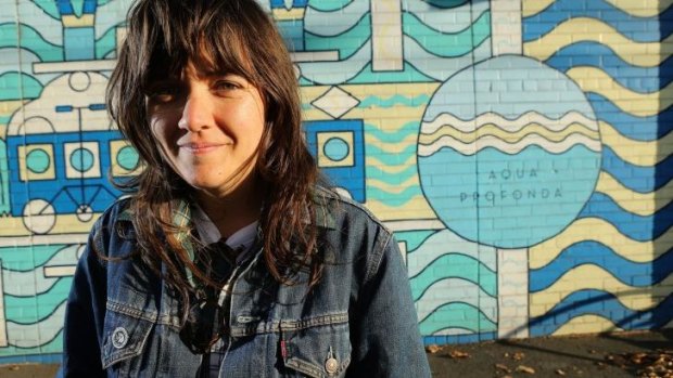 MELBOURNE, AUSTRALIA - APRIL 20:  Singer-songwriter and guitarist Courtney Barnett poses for a photo  in front of the Aqua Profunda sign  at the Fitzroy Pool on April 20, 2015 in Melbourne, Australia.  (Photo by Pat Scala/Fairfax Media) *** Local Caption *** Courtney Barnett