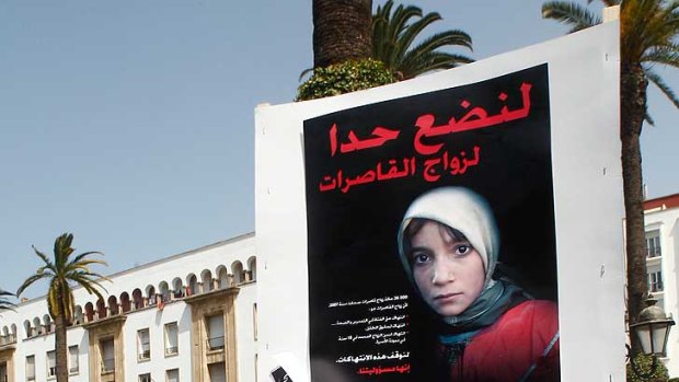 Women hold posters of victims as they protest in support of Amina Filali who committed suicide last week, in front  ofthe Moroccan parliament in Rabat.