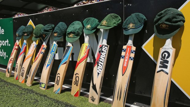 Cameraderie: The bats and caps of the Australian cricket team are left by the field in a tribute to the late Phillip Hughes during day one of the First Test between Australia and India at the Adelaide Oval.