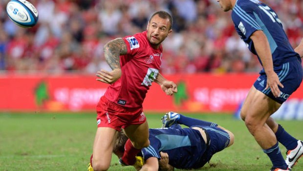 Quade Cooper of the Reds gets a pass away at Suncorp Stadium last week.