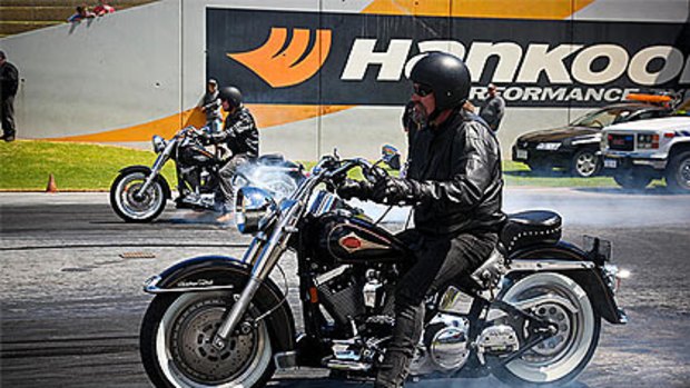 Motorbike riders peel out rubber during the drag racing event at Perth Motorplex which was marred by a bikie brawl.