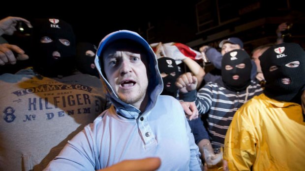 Members of the English Defence League wear balaclavas as they gather outside a pub in Woolwich in London on Wednesday, May 22.