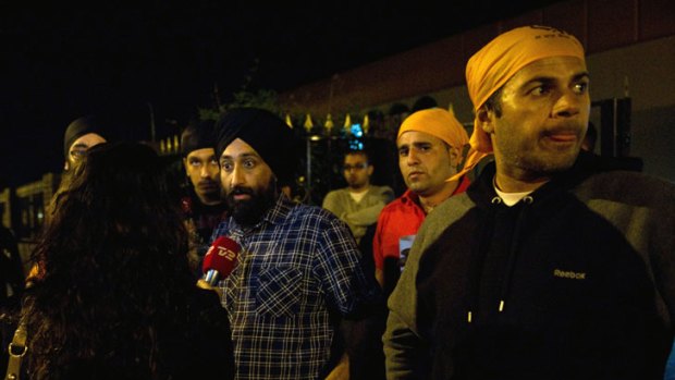 Defiance ... Sikhs gather outside a temple in Southall.