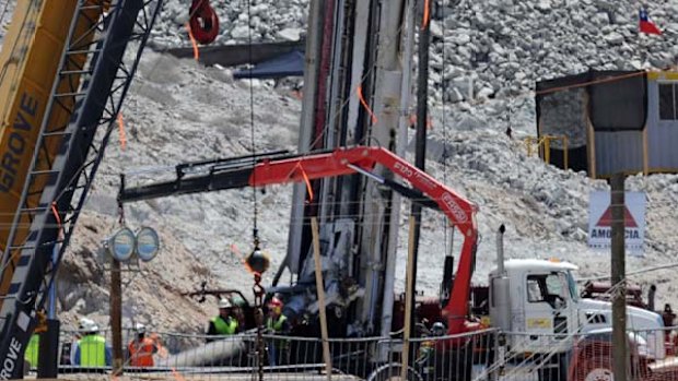 Almost there ... workers reinforce the exit shaft through which the 33 trapped miners will be lifted out.