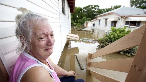 Anne Smart returns to her devastated home at Ipswich, south-west of Brisbane, to find the ground floor entirely flooded.