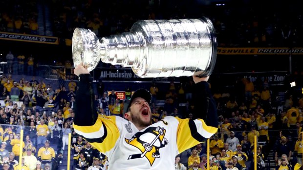 Sidney Crosby of the Pittsburgh Penguins celebrates with the Stanley Cup Trophy.