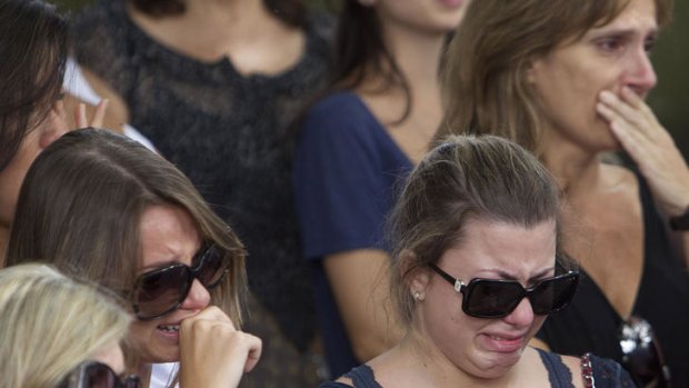 Friends and relatives of Brazilian student Roberto Laudisio Curti weep during his burial service in Sao Paulo.