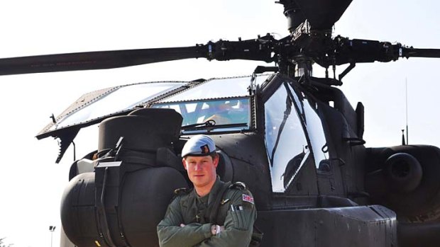 Prince Harry with an Apache helicopter.