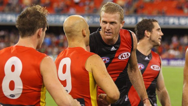Gary Ablett of the Suns congratulates Dustin Fletcher of the Bombers after his 350th game.
