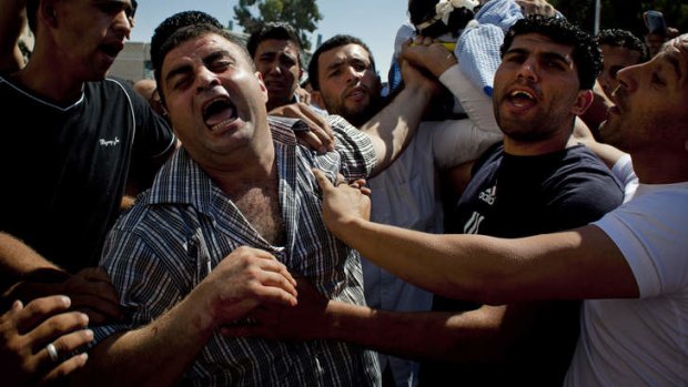 Palestinian mourners carry the body of a 19-year-old man killed in clashes in the West Bank early on Monday.