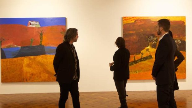 3.45pm: Daniel Mudie Cunningham, left, and Tony Stephens, right, examine landscapes by Idris Murphy.