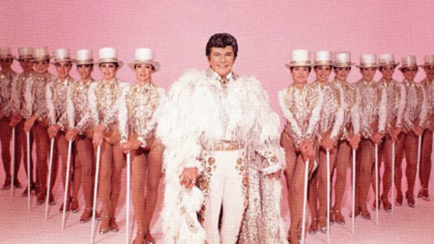 Flamboyant ... Liberace with the Radio City Music Hall Rockettes in 1984.