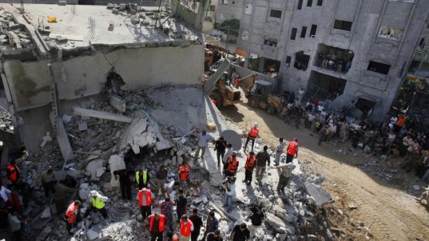 Palestinian rescuers search for survivors under the rubble of a Hamas house in Gaza City in 2006. Mohammed Deif was wounded in the attack and operated on.