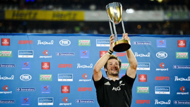 Richie McCaw holds up the Rugby Championship trophy.
